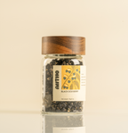 Jar of black goji berries with a wooden lid on a beige background perfect gift for tea lover 