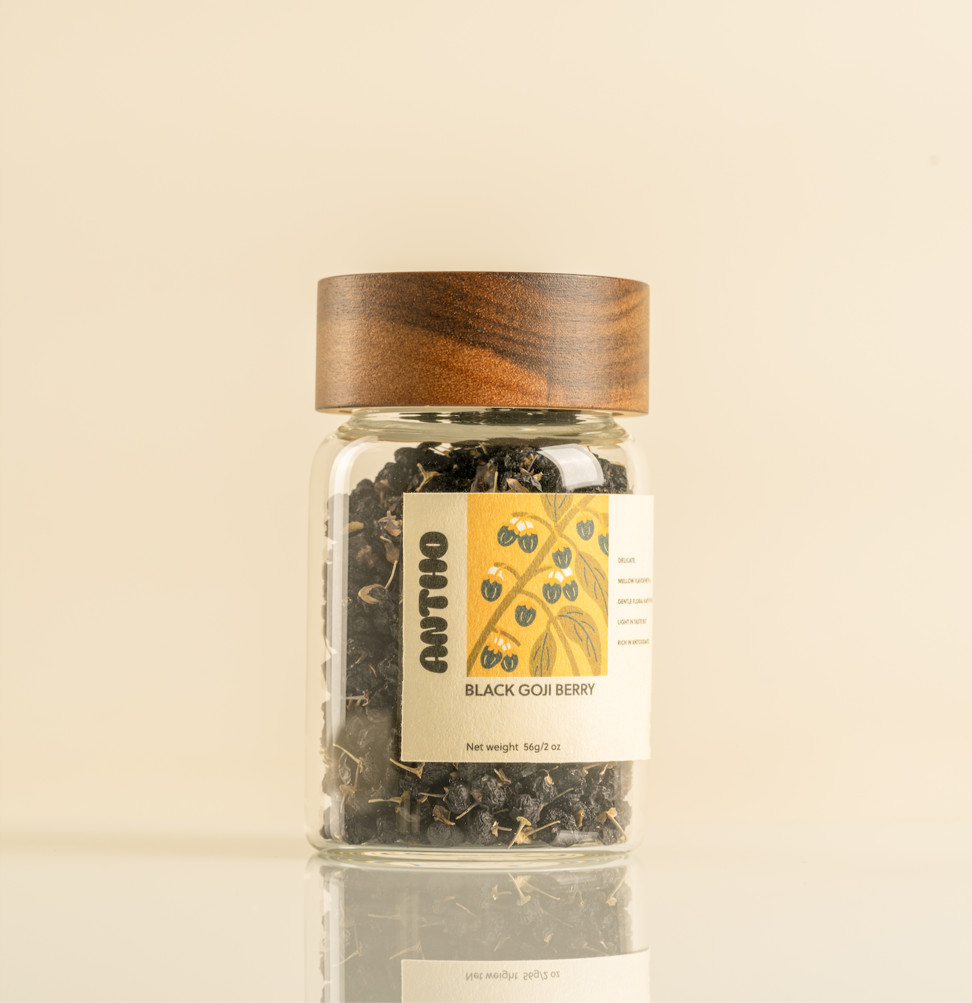 Jar of black goji berries with a wooden lid on a beige background perfect gift for tea lover 