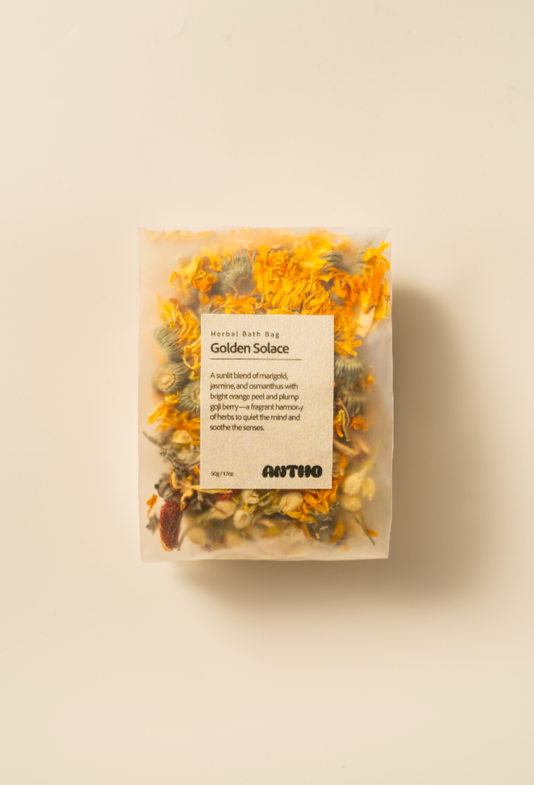Golden Solace herbal bath bag with golden blossoms for fatigue relief